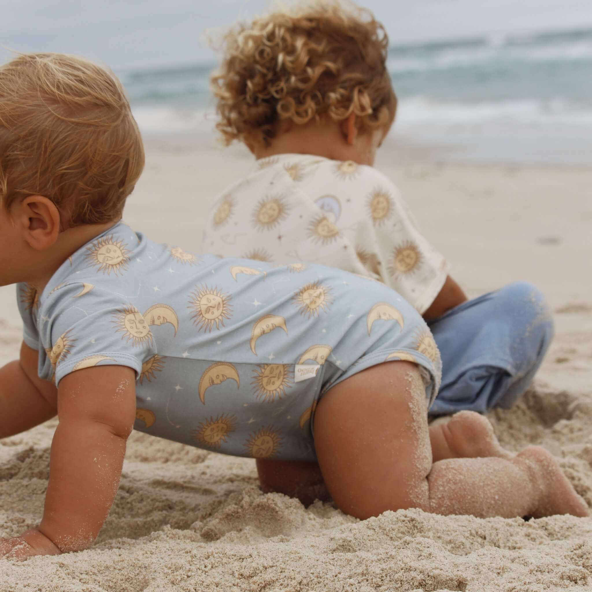 Celestial Short Sleeved baby Onesie | Blue suns moons and stars