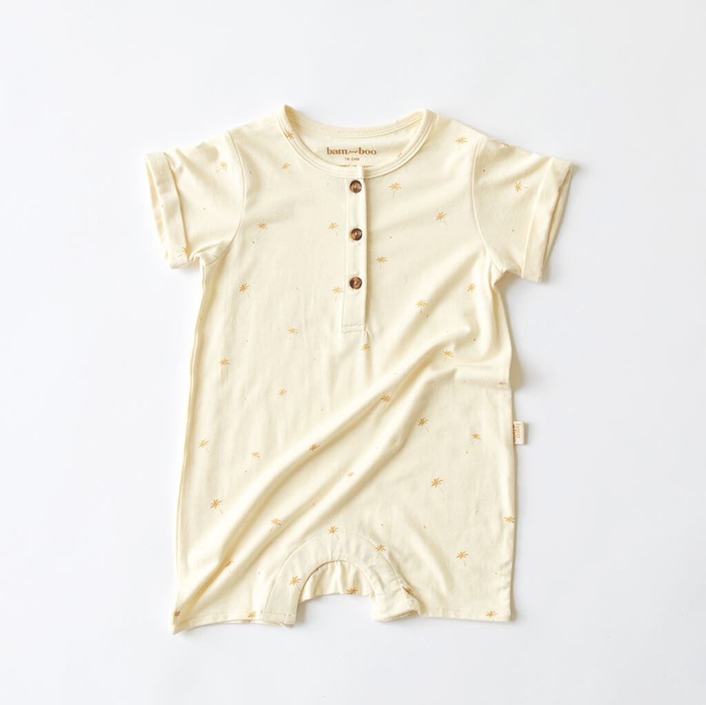 cream baby jumpsuit onesie with palm tree print and button up front