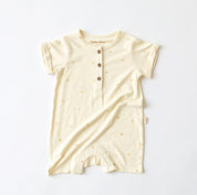 cream baby jumpsuit onesie with palm tree print and button up front
