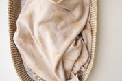 Baby Wrapped in Organic Cotton blanket with Palm tree jacquard by Bam Loves Boo