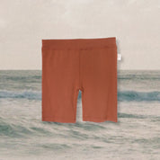 rust-bike-pants-kids-ocean-background
