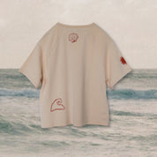 back of oat colour kids bamboo raglan tee with shell sun and wave print