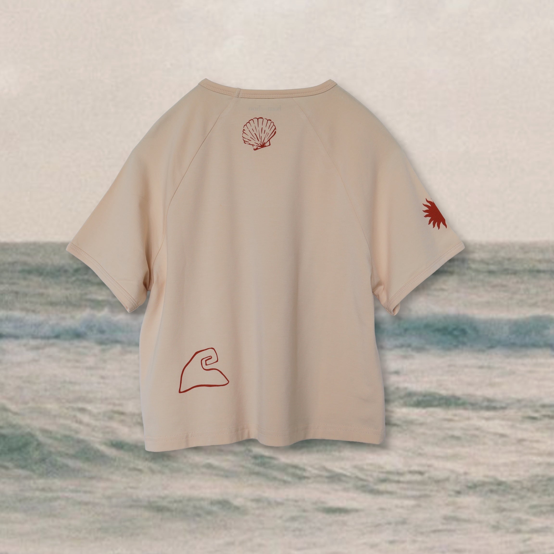 back of oat colour kids bamboo raglan tee with shell sun and wave print