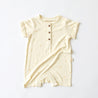 cream baby jumpsuit onesie with palm tree print and button up front