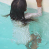 Girls stripe long sleeve swimsuit in pool