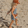 Rust Rainbow corduroy kids cap and bumbag on beach