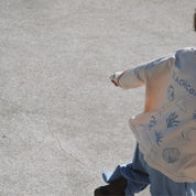 Child walking away on concrete in Beachcomber long sleeve tee, showing full back design and easy movement.