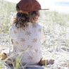 child sat in sand in bamboo palm tree tee