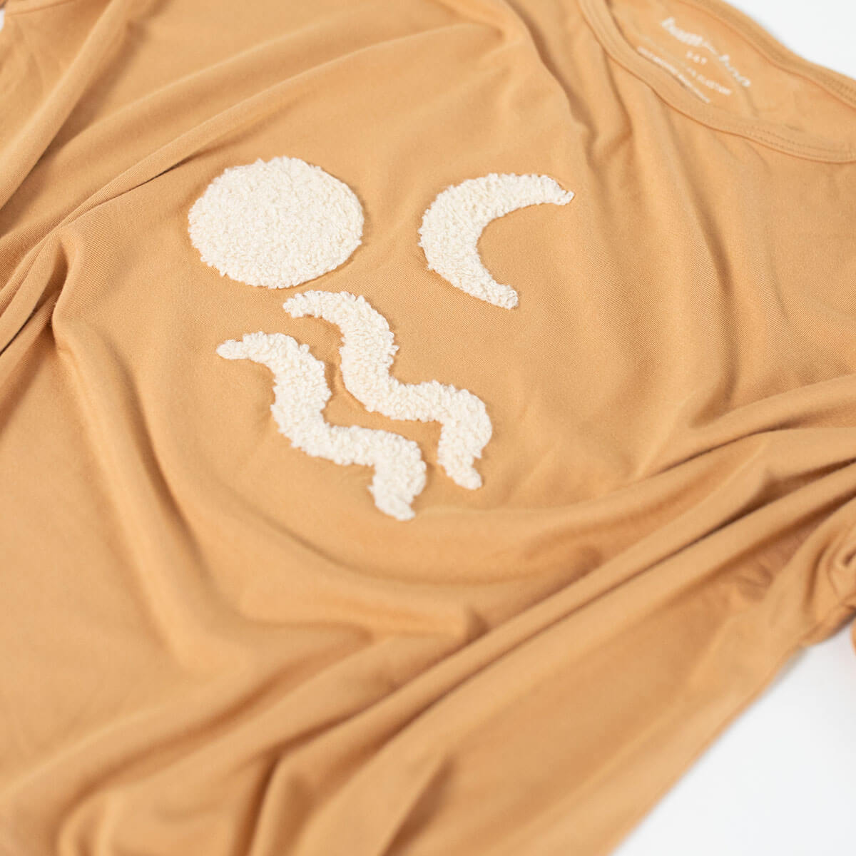 cream boucle embroidery on terracotta top