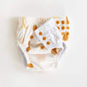 Apricot abstract shapes baby swim nappy by bare and boho