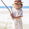 child on beach  wearing Oasis Moon Palm Kids tee by Bam Loves Boo