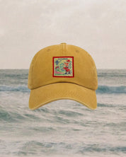 Yellow cap with a colorful patch on a water background