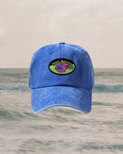 Blue cap with a 90s style logo on a ocean background
