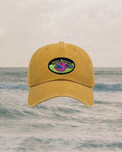 Yellow cap with a scout australia logo on a beach background