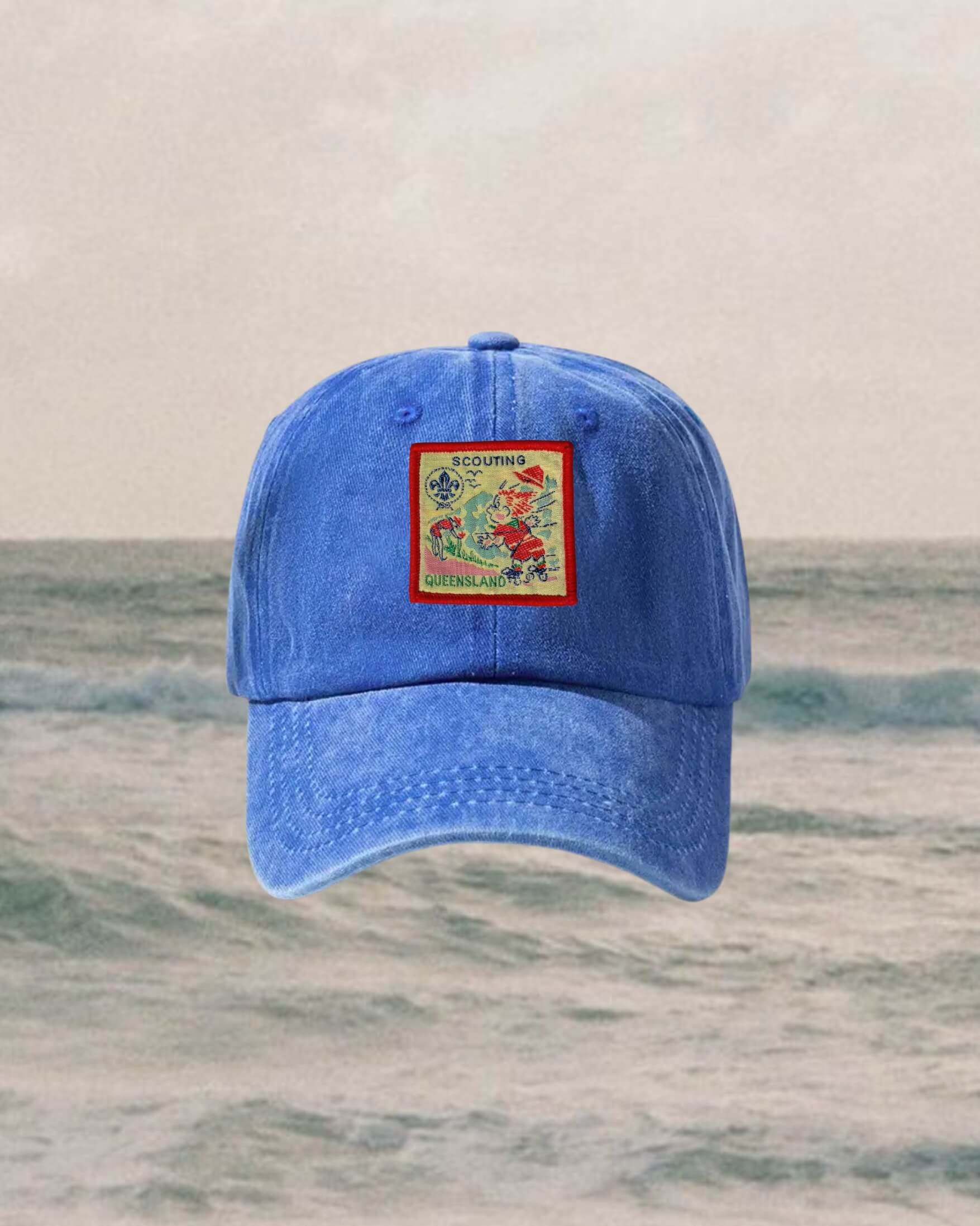 Blue cap with a colorful patch on a water background