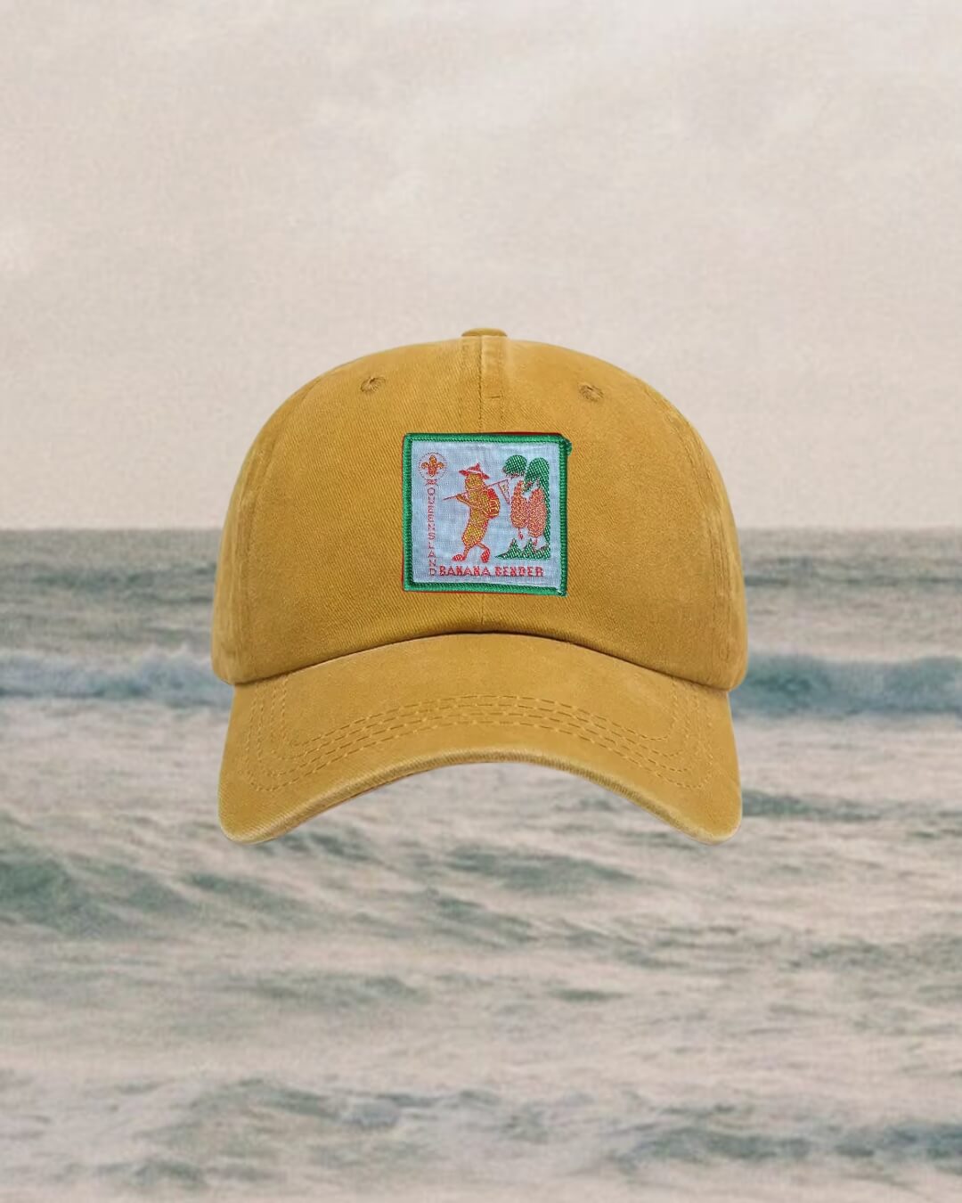 kids Yellow cap with a logo on a ocean background