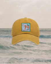 kids Yellow cap with a logo on a ocean background
