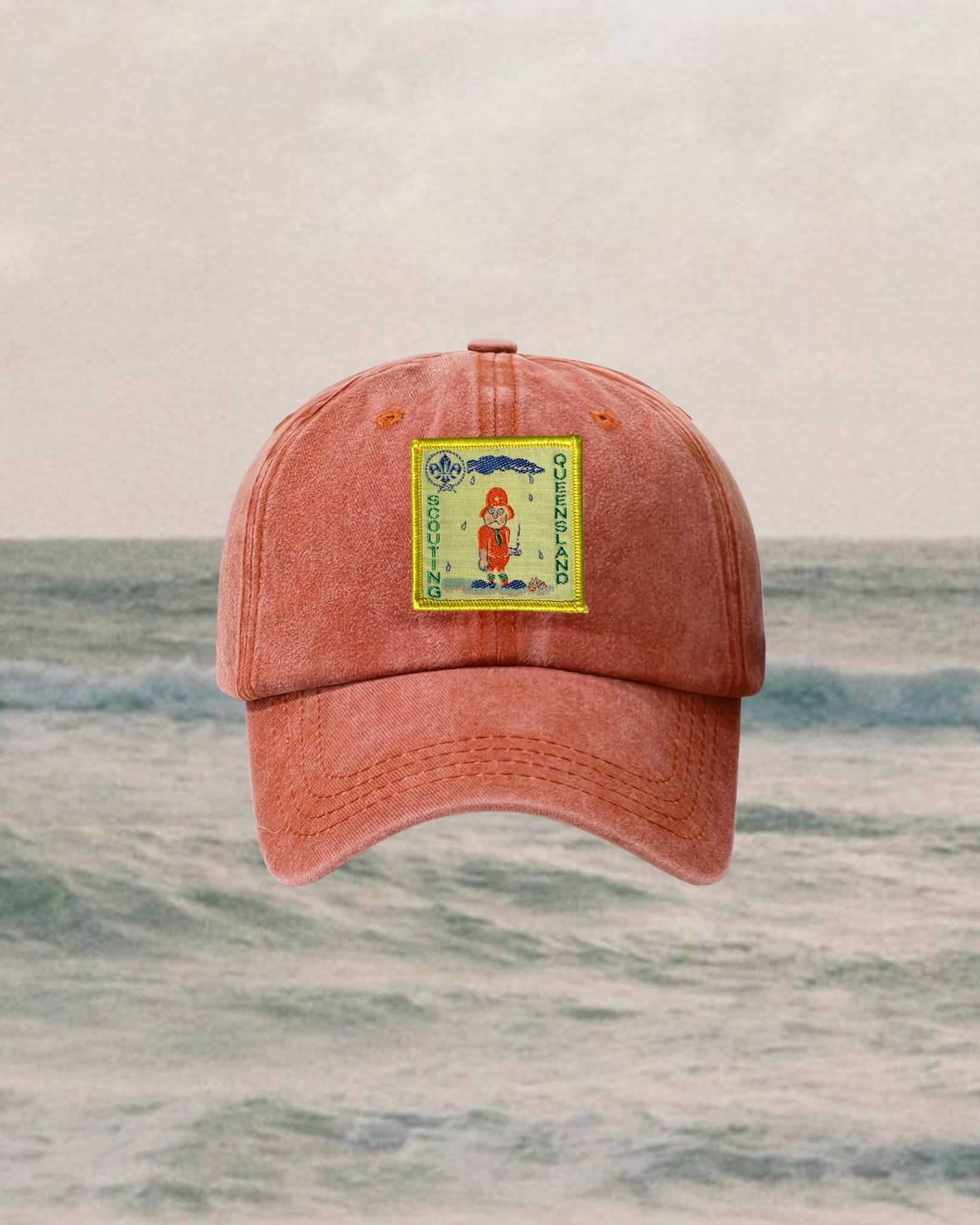 red cap with a yellow patch on a ocean background