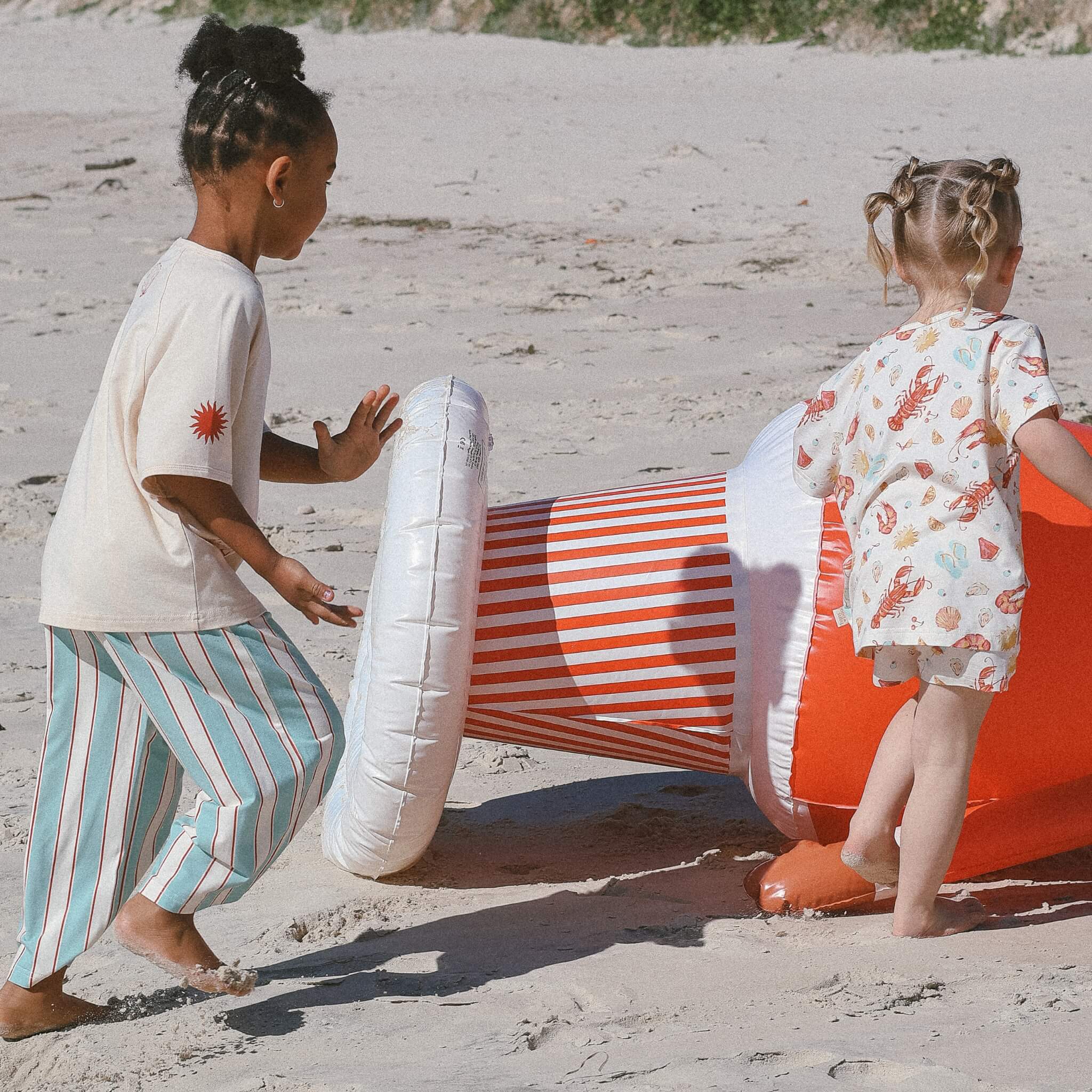 kids wearing cream tee and blue and cream stripe pants and aussie christmas PJs