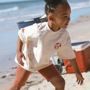 child-wearing-rust-bike-pants-cream-tee-running