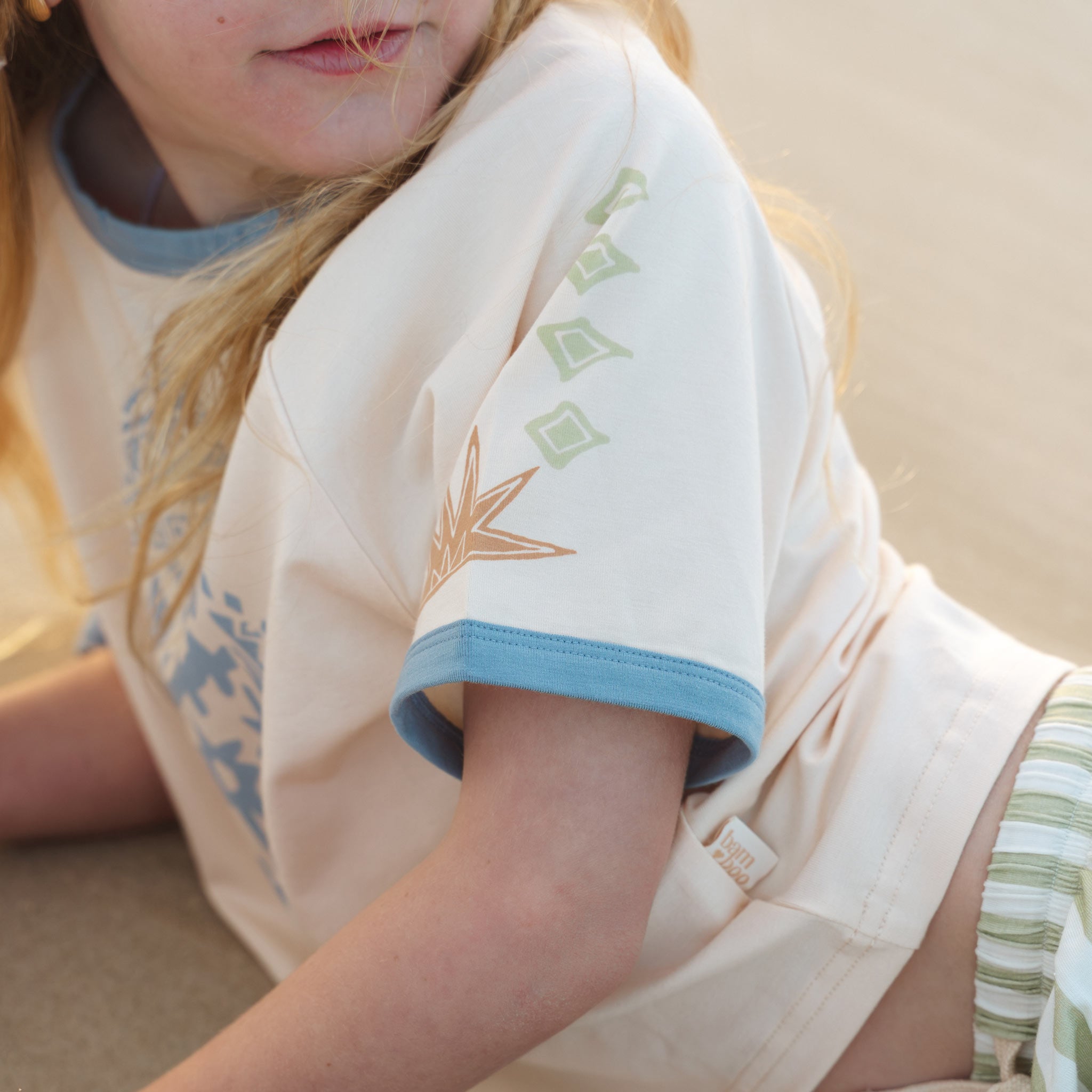 Close up of the sleeve print detail on the Kailani raglan tee by Bam Loves Boo