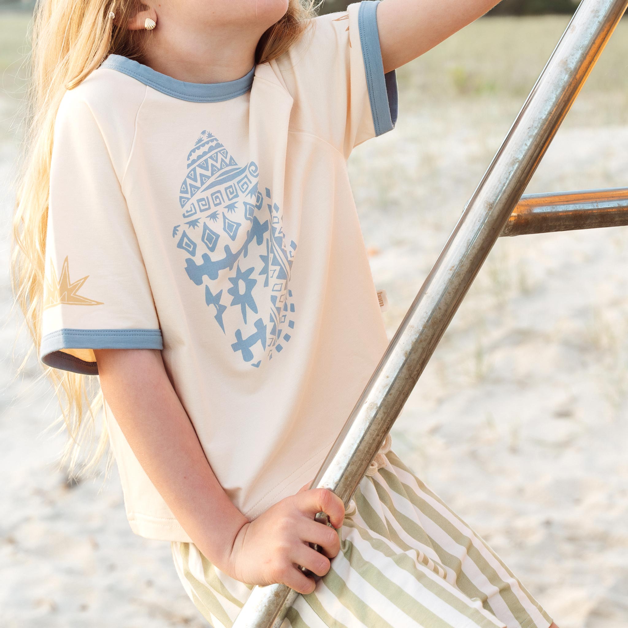 Cream raglan tee with a blue Kailani shell print on the chest by Bam Loves Boo