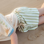 Close up of sage green and cream striped shorts fabric and drawstring tie by Bam Loves Boo