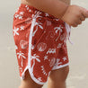 Red swim boardshorts shells palm tree waves