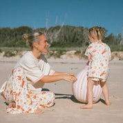 mum and daughter wearing cream PJ's with Aussie christmas print lobsters, prawns, shells, sun.