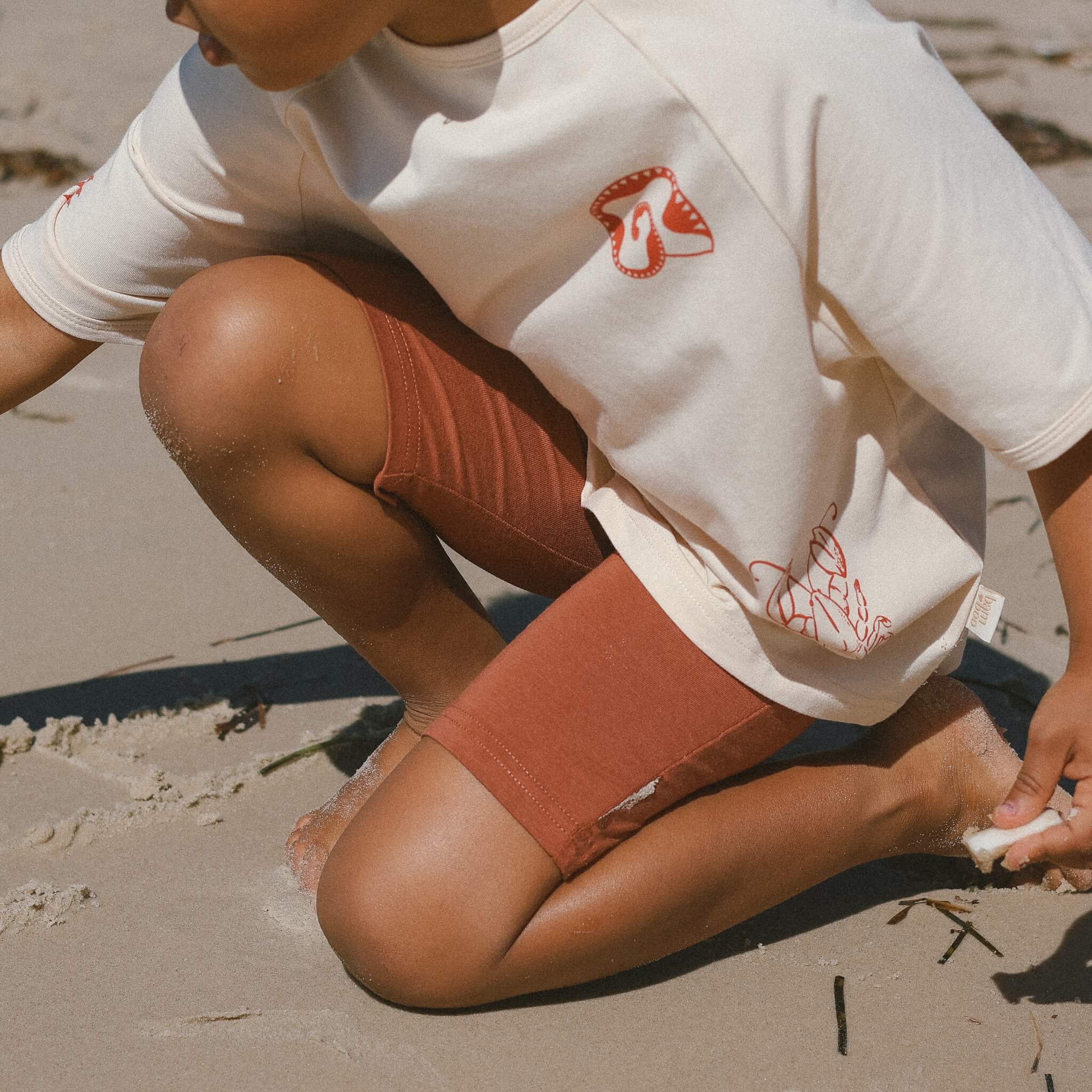 close-up-child-wearing-rust-bike-pants-cream-tee-bamboo