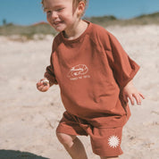 child-playing-beach-inrust-shorts-tee-withshrimp-print