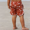 Red swim boardshorts with printed shells palm tree waves