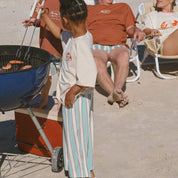 child playing with BBQ on beach in Bam Loves Boo Clothing