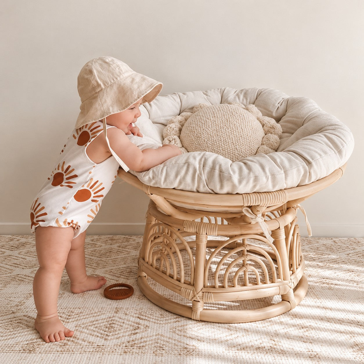 Baby holding and chewing the Clay silicone sun teether
