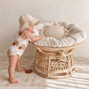 Baby holding and chewing the Clay silicone sun teether