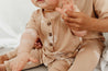 Short sleeve baby Jumpsuit with all over palm print in honey colour by Bam Loves Boo