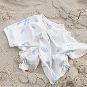 Kids bamboo tee with cream and blue print on sand